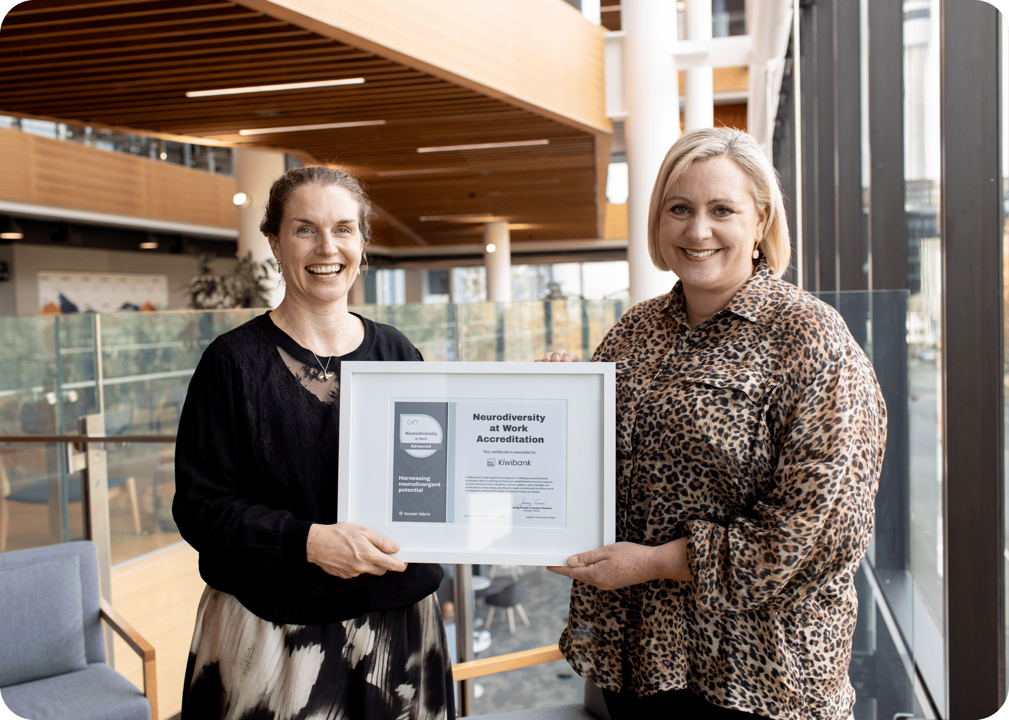 Charlotte Ward and Jenny Turner holding the Kiwibank Neurodiversity at Work Certificate