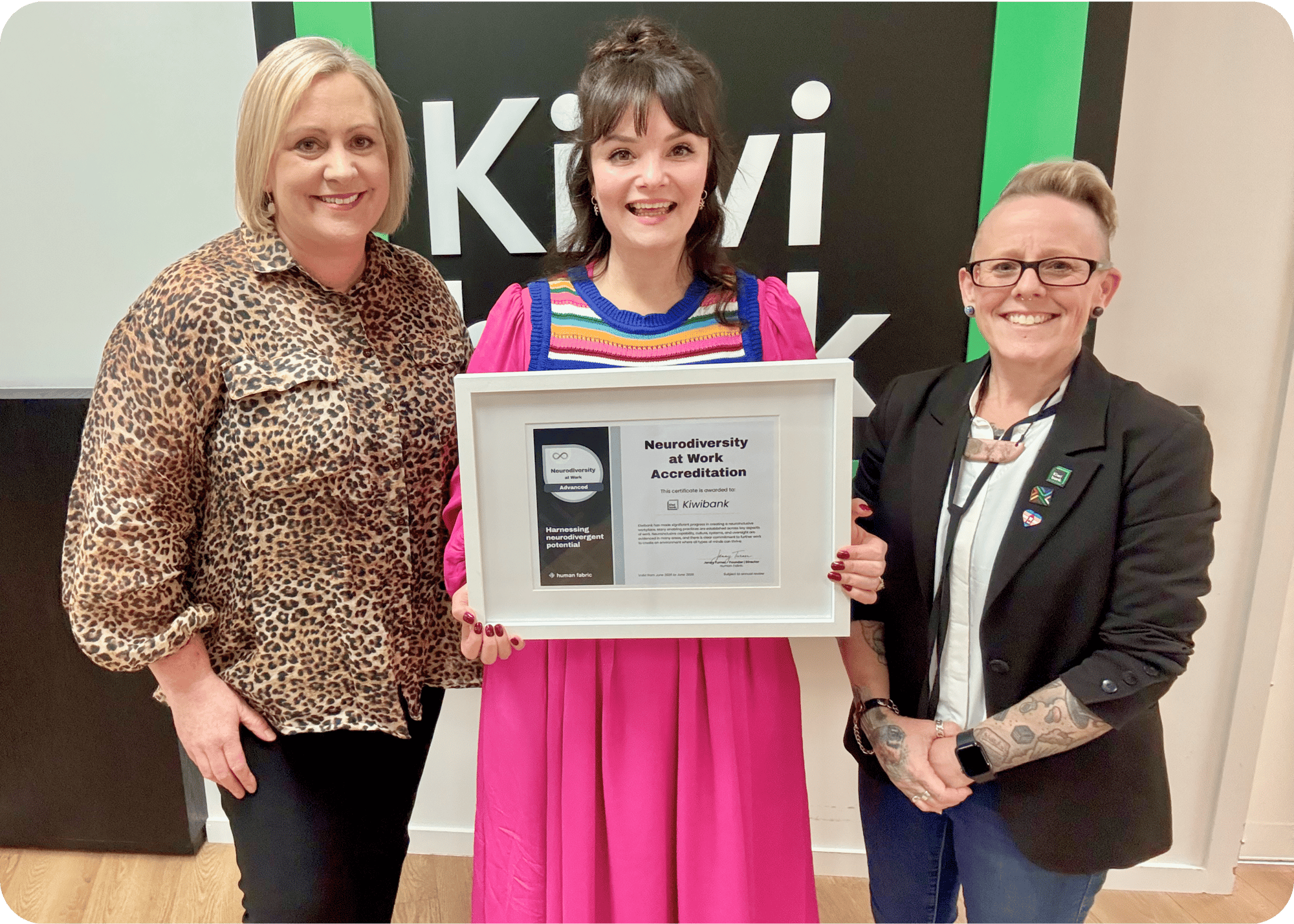 Jenny Turner and Kiwibank staff holding the Neurodiversity at Work Accreditation certificate