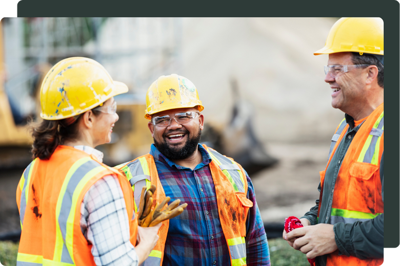 three construction workers wearing PPE gear on-site
