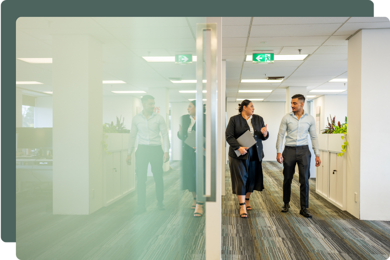 Two people walking in a New Zealand workplace setting